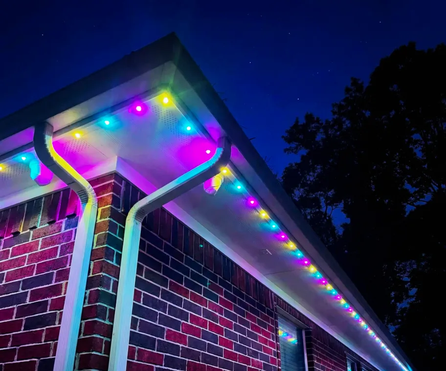 Permanent outdoor lighting in white installed under a white home's fascia.