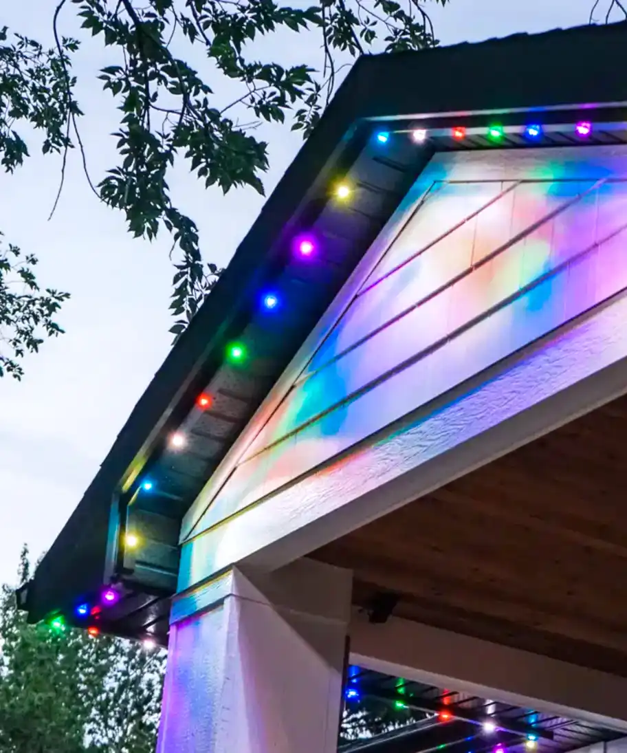 Home with their permanent outdoor lighting on in multiple colors.