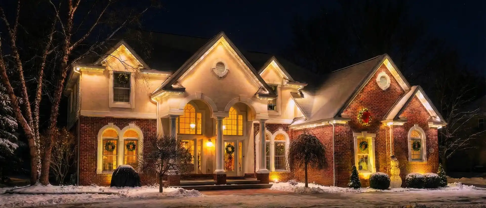 Close up of a home with permanent outdoor lights installed.
